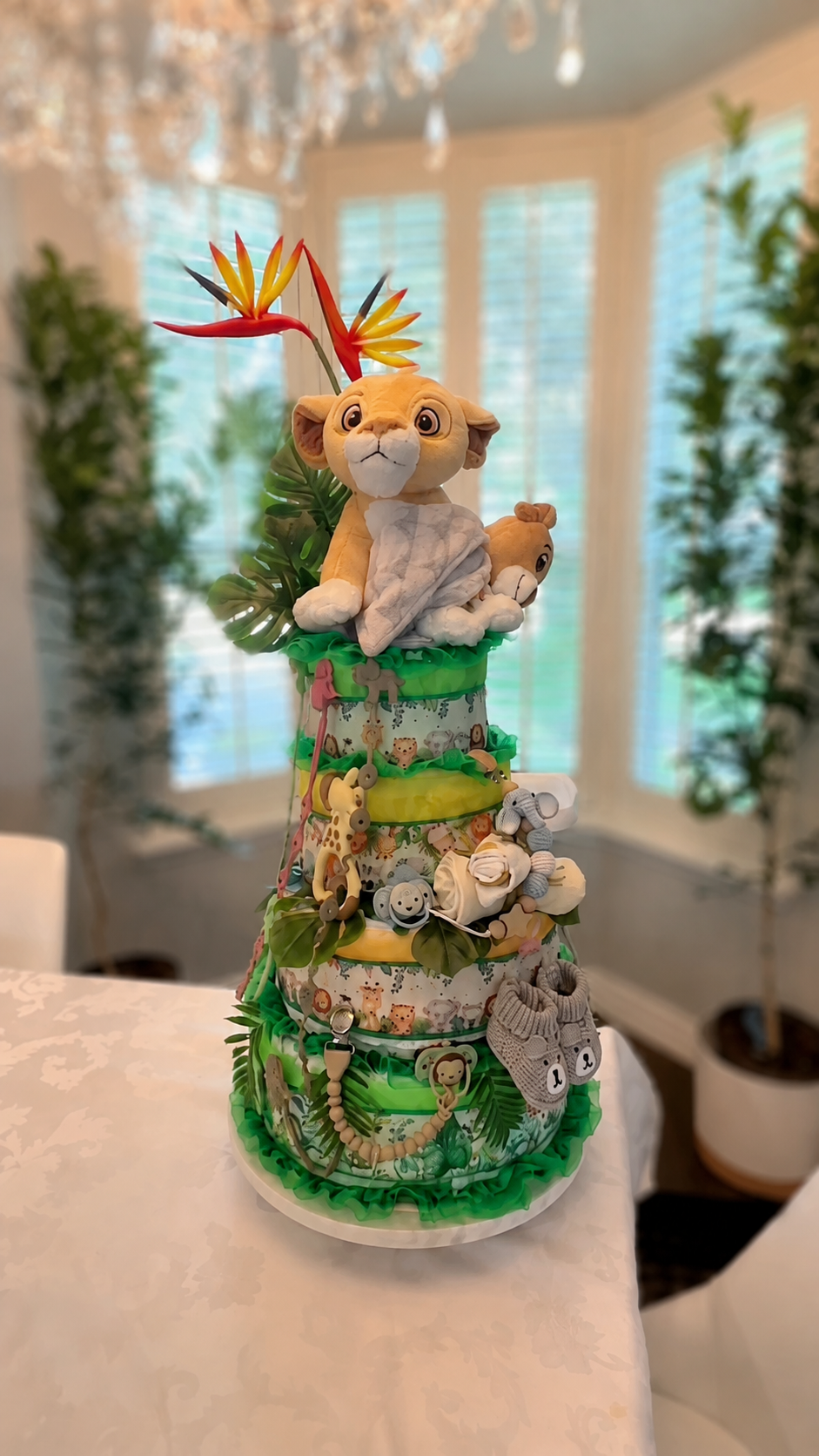 Green safari-themed custom diaper cake with lion topper